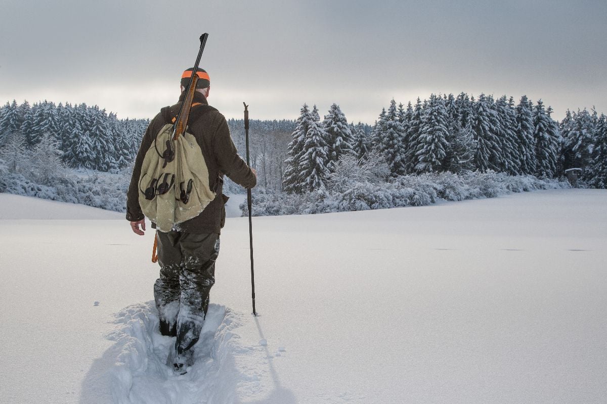 A man hunting in snow.