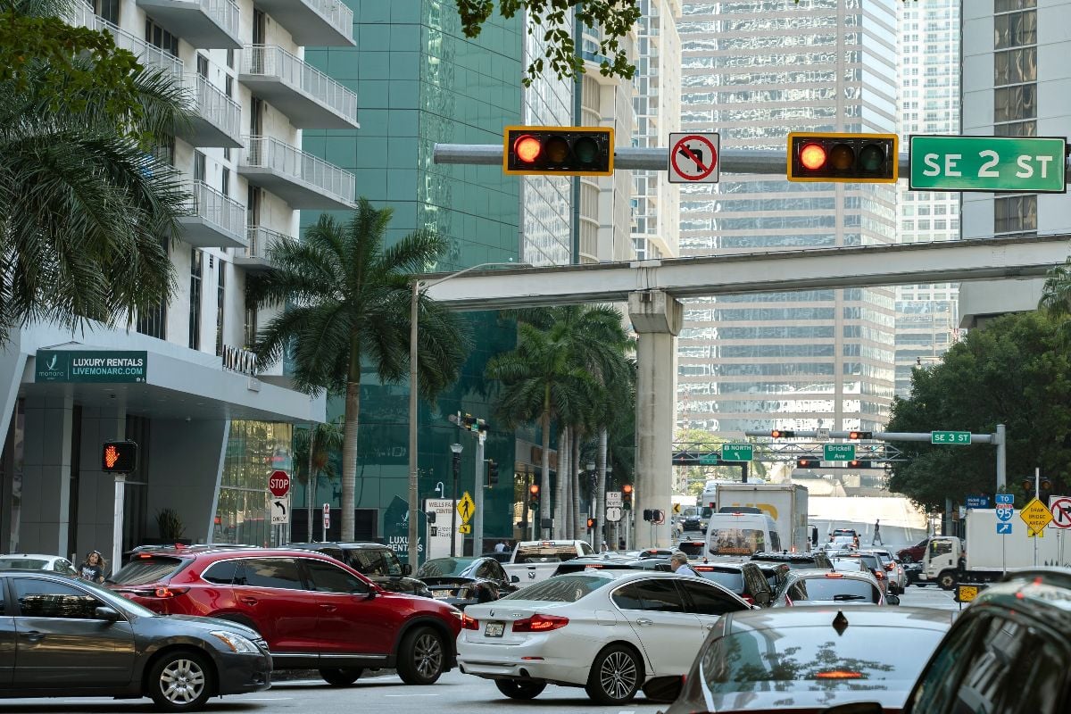 Traffic lights regulating driving cars on city street in Miami, Florida.