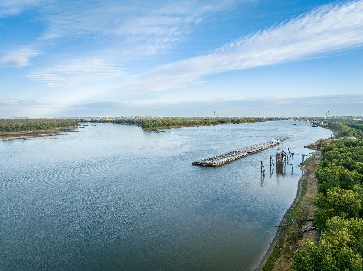 Towboat with barges on the Mississippi River at confluence with the Missouri River.