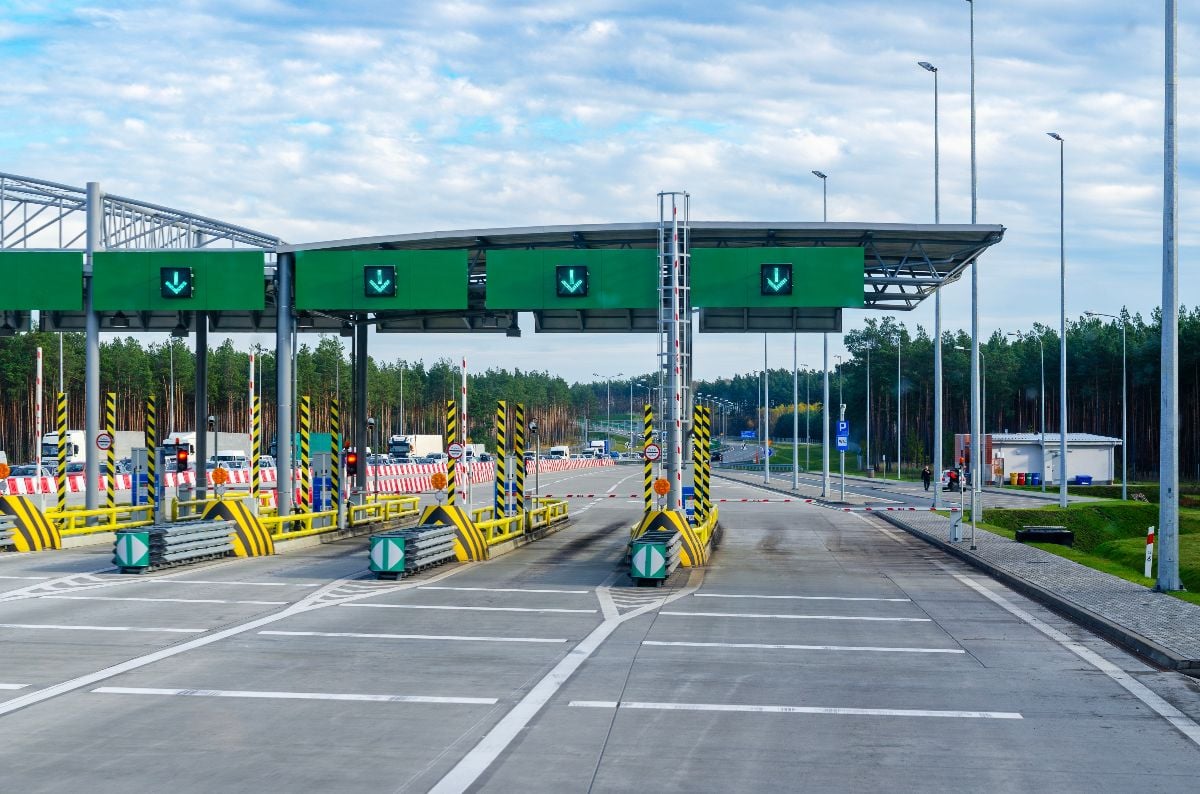 Modern highway toll plaza with electronic toll collection gate.