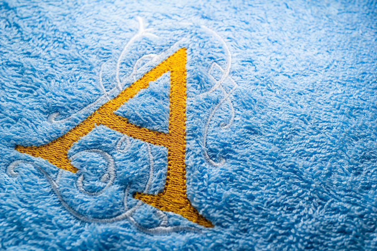 Embroidered A monogram on a blue towel.
