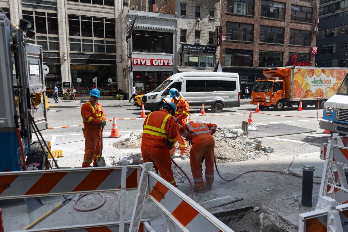 Construction workers doing road work in Midtown Manhattan of New York City.