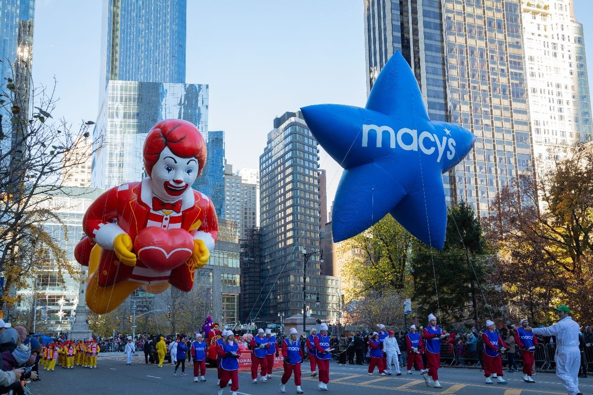 Wide angle landscape image of Ronald McDonald balloon, following the Macy's star balloon during the Macy's Thanksgiving Day Parade. 