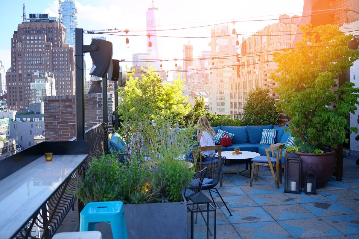 New York City rooftop with couch and chairs.