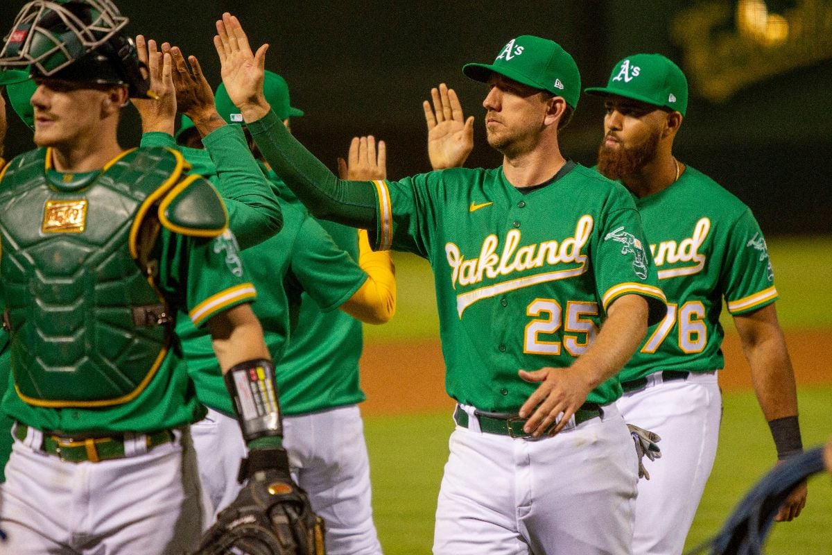 Sean Murphy, Stephen Piscotty, Dermis Garcia, and the Oakland Athletics high five after beating the Texas Rangers.