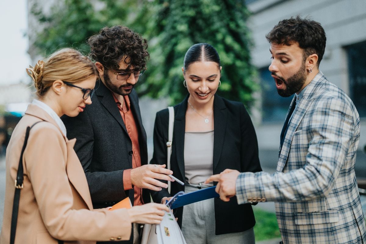 A diverse group of business people brainstorming ideas during an outdoor meeting.