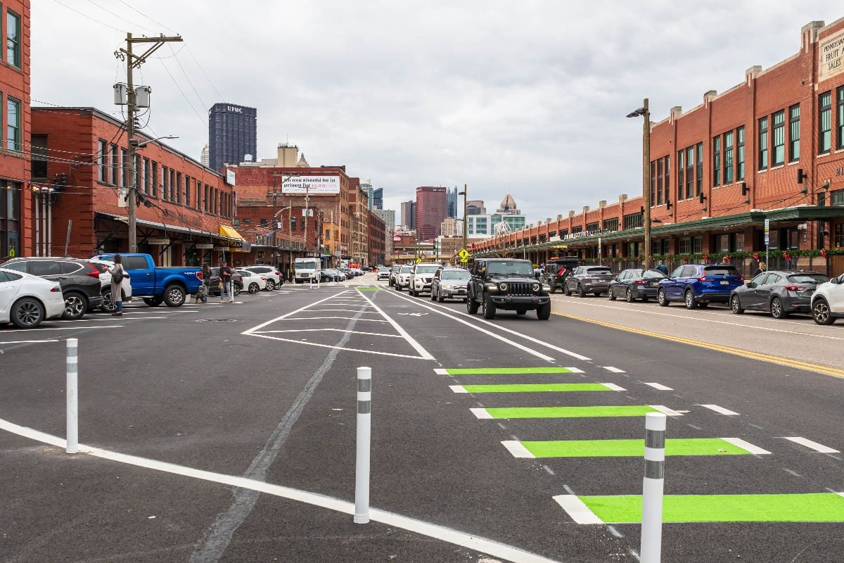 Traffic and parked cars along Smallman Street in the Strip District neighborhood on an overcast fall day.
