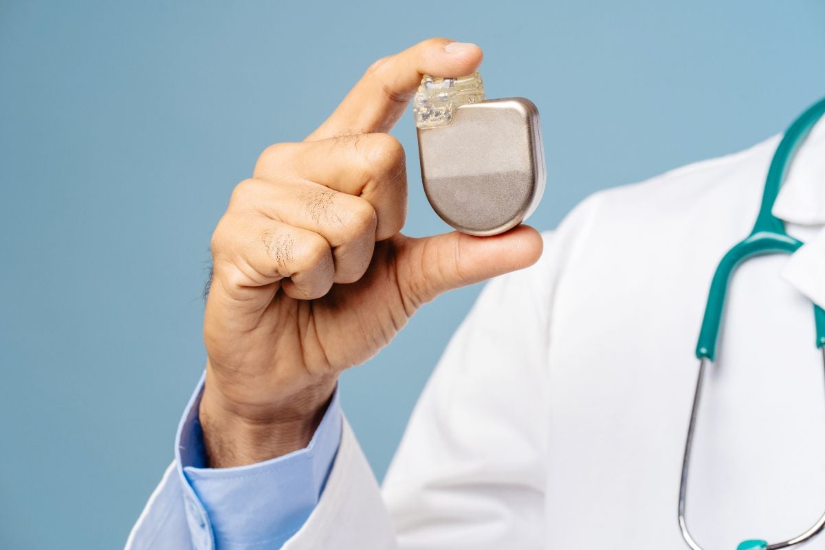 Cardiologist holding a pacemaker.