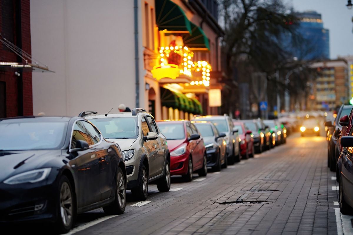 Row of parked cars filling every available roadside space.