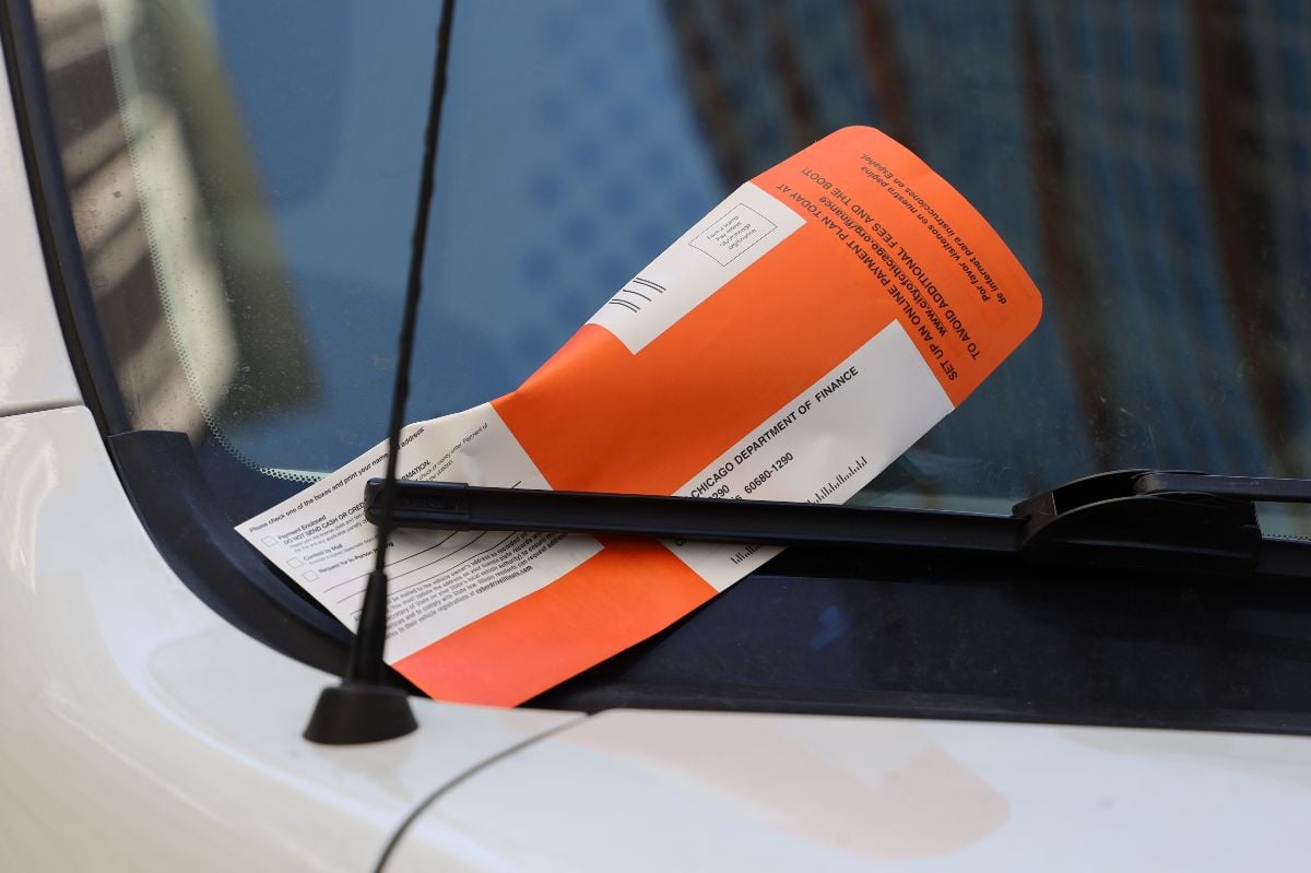 Illegal parking violation citation on car windshield.
