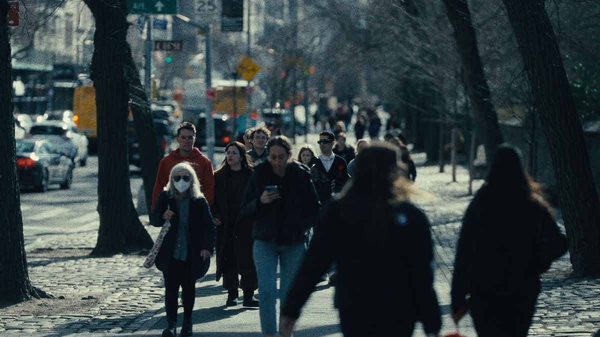 People walking on sidewalk in Manhattan, New York City.