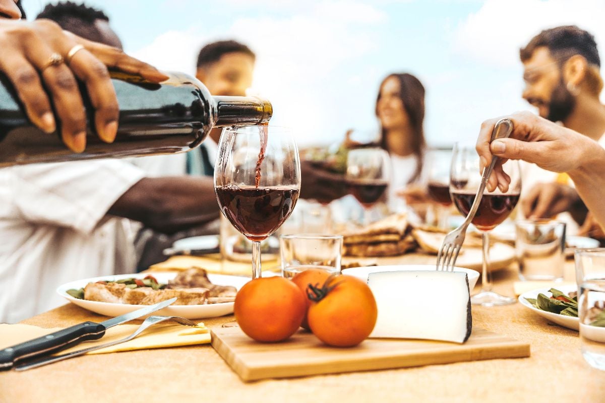 A group of friends drinking red wine.