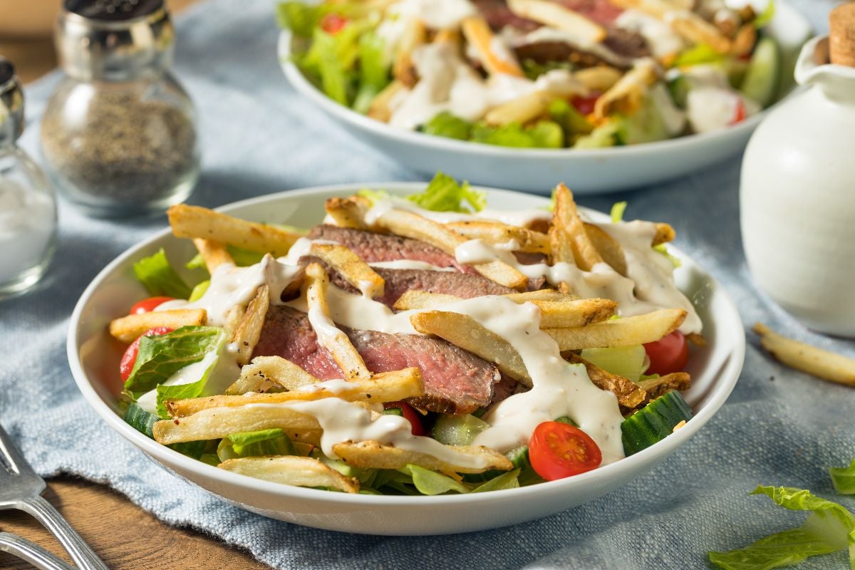 Homemade Pittsburgh salad with steak and french fries.