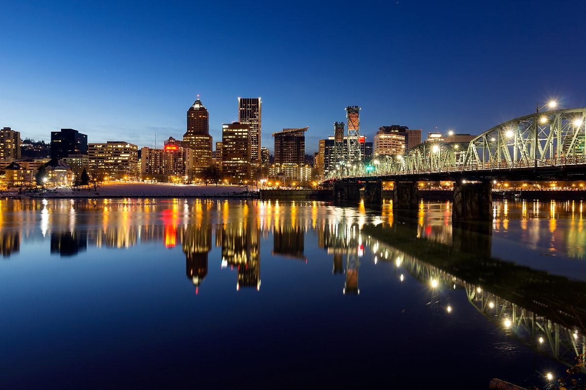 Portland Oregon downtown skyline along Willamette River during blue hour.