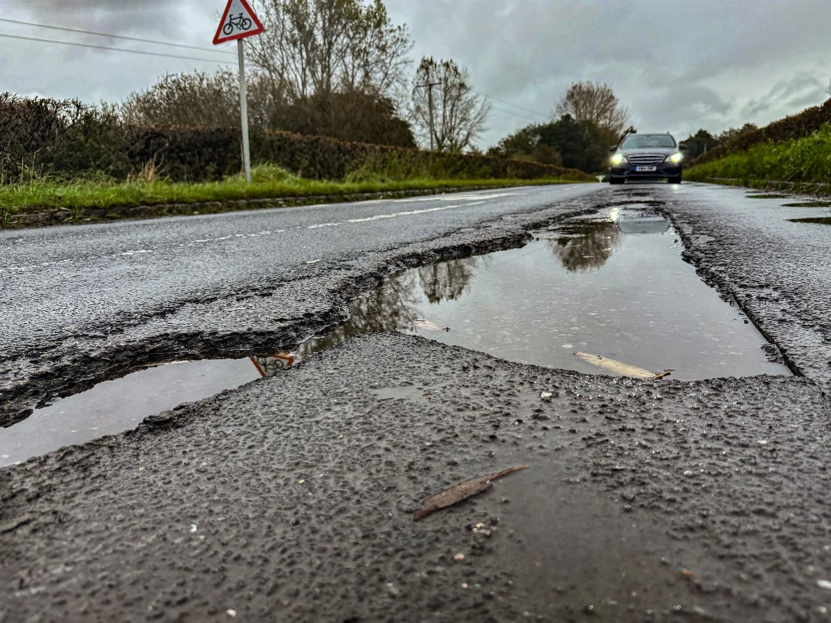 Potentially tyre-ripping water-filled potholes on the road.