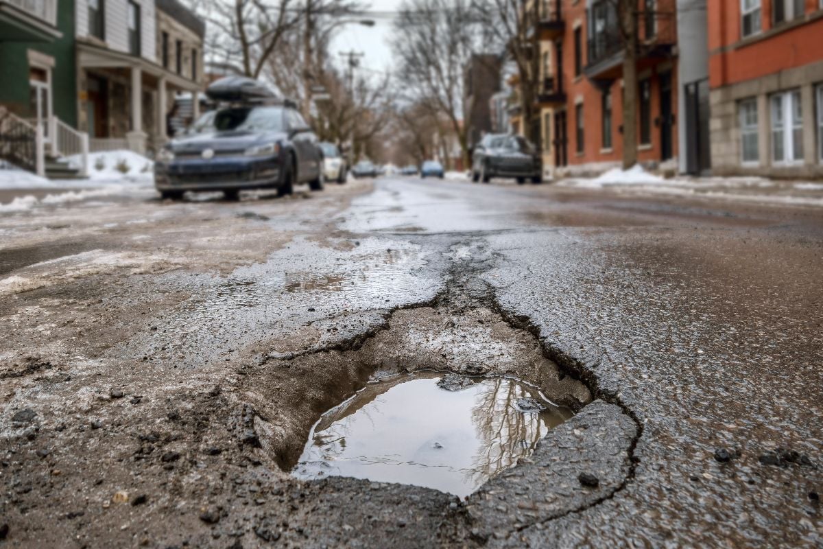 Large deep pothole during winter.