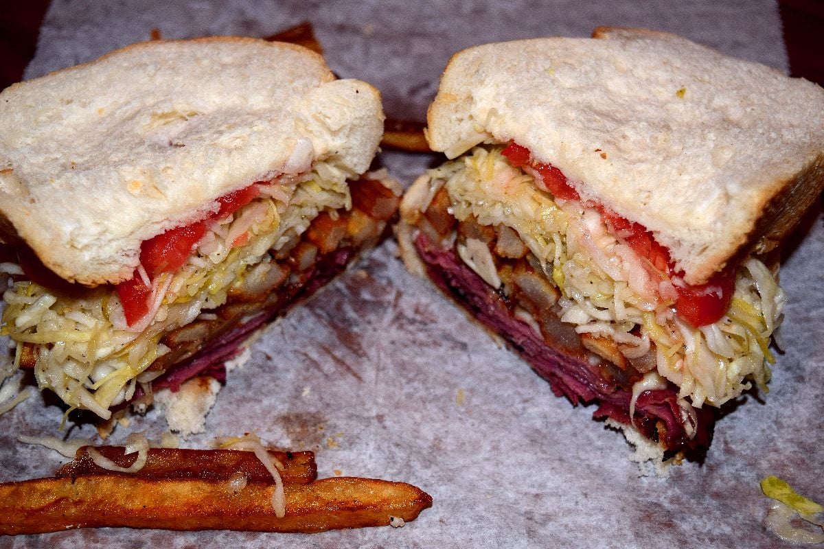 Primanti signature sandwich with meat, cheese, slaw, and fries.