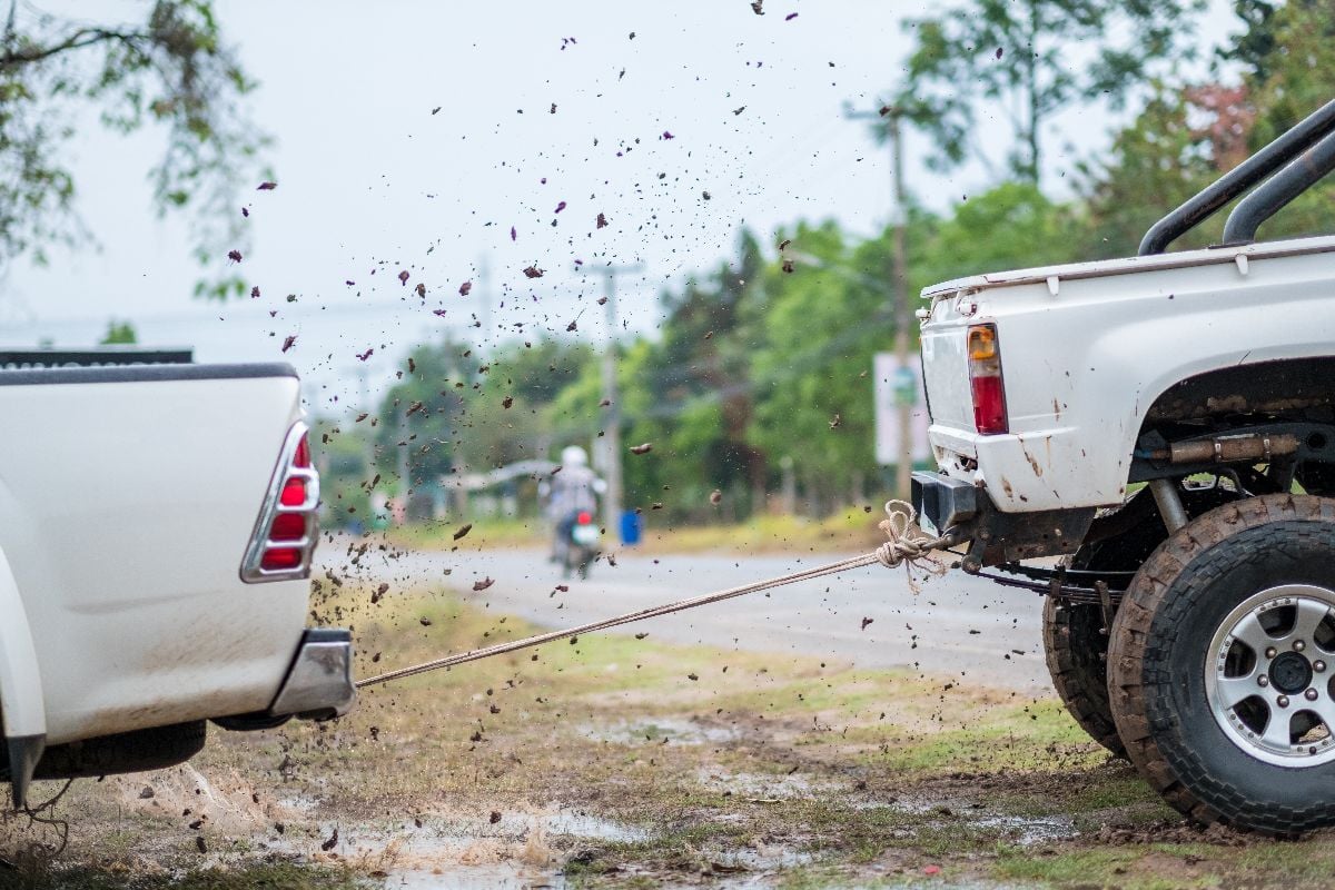 Driver pulls the car out of the mud.