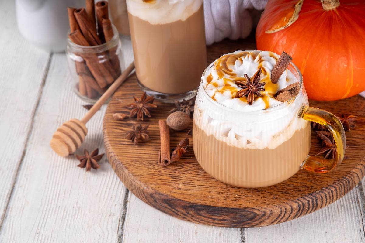 Pumpkin pie spices latte drink on a wooden board.
