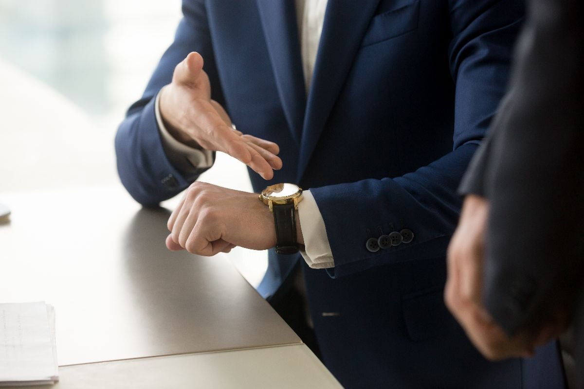 Businessman disappointed with partner's punctuality.