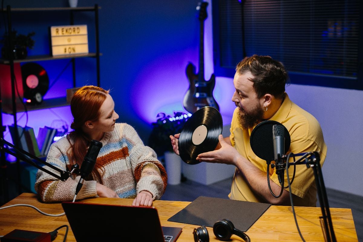 A radio presenter talks to a guest in the studio.