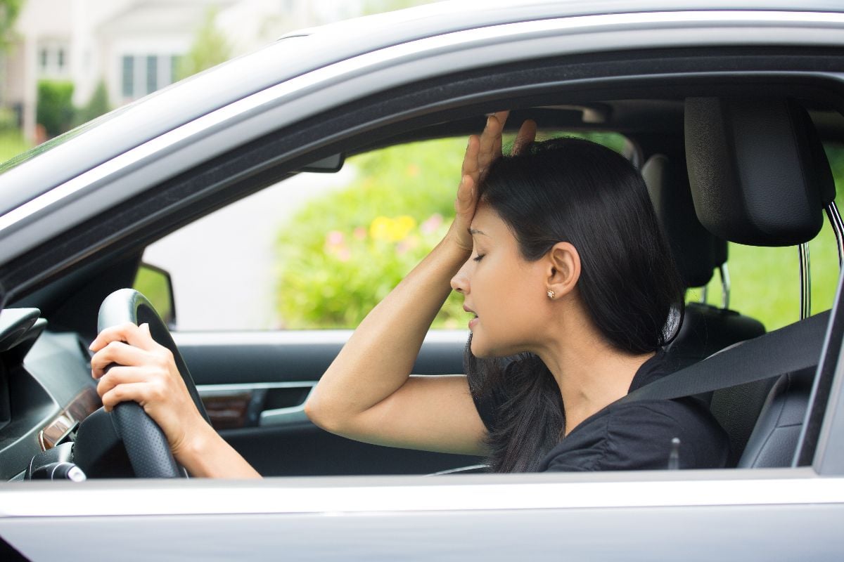 Woman frustrated inside the car.