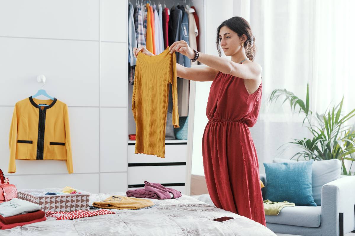Woman choosing clothes on her wardrobe.
