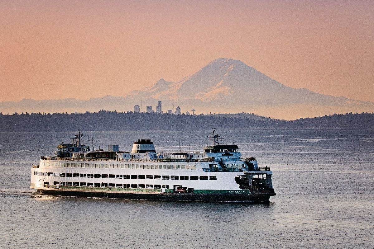 Washington state ferry crossing in front of Mt Rainier and Seattle. 
