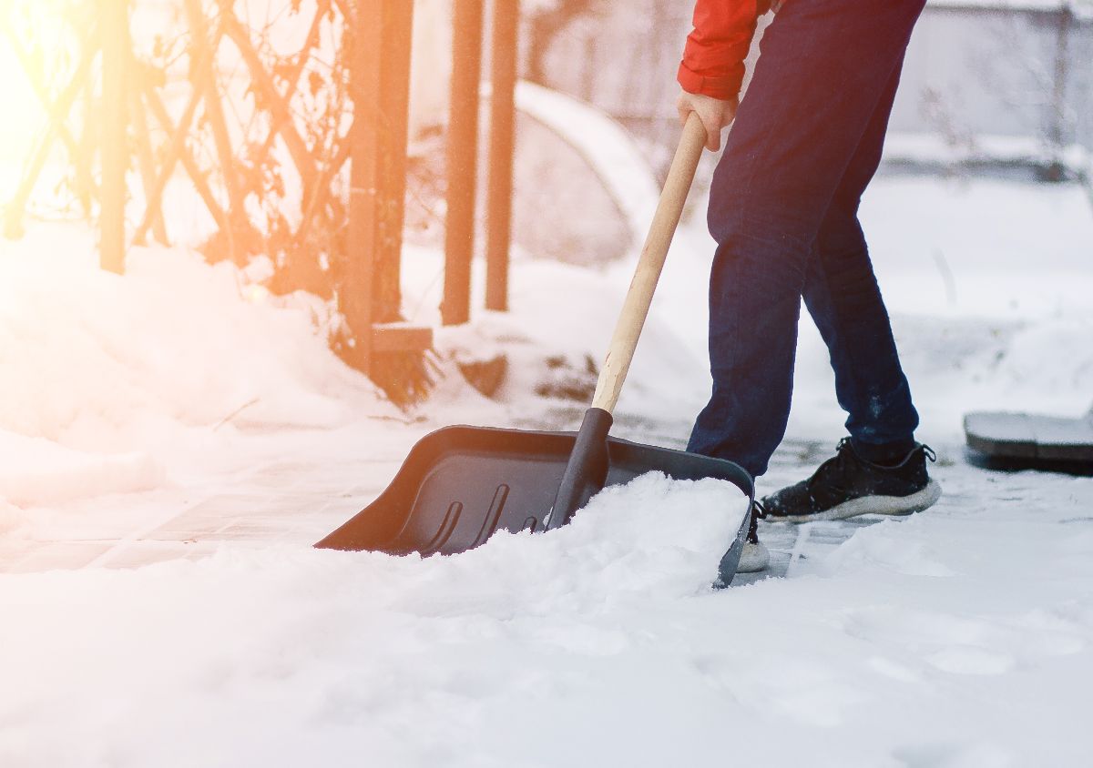 Man shoveling snow on the street.