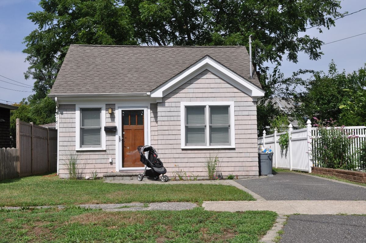 Suburban bungalow home with baby carriage in front of the house.