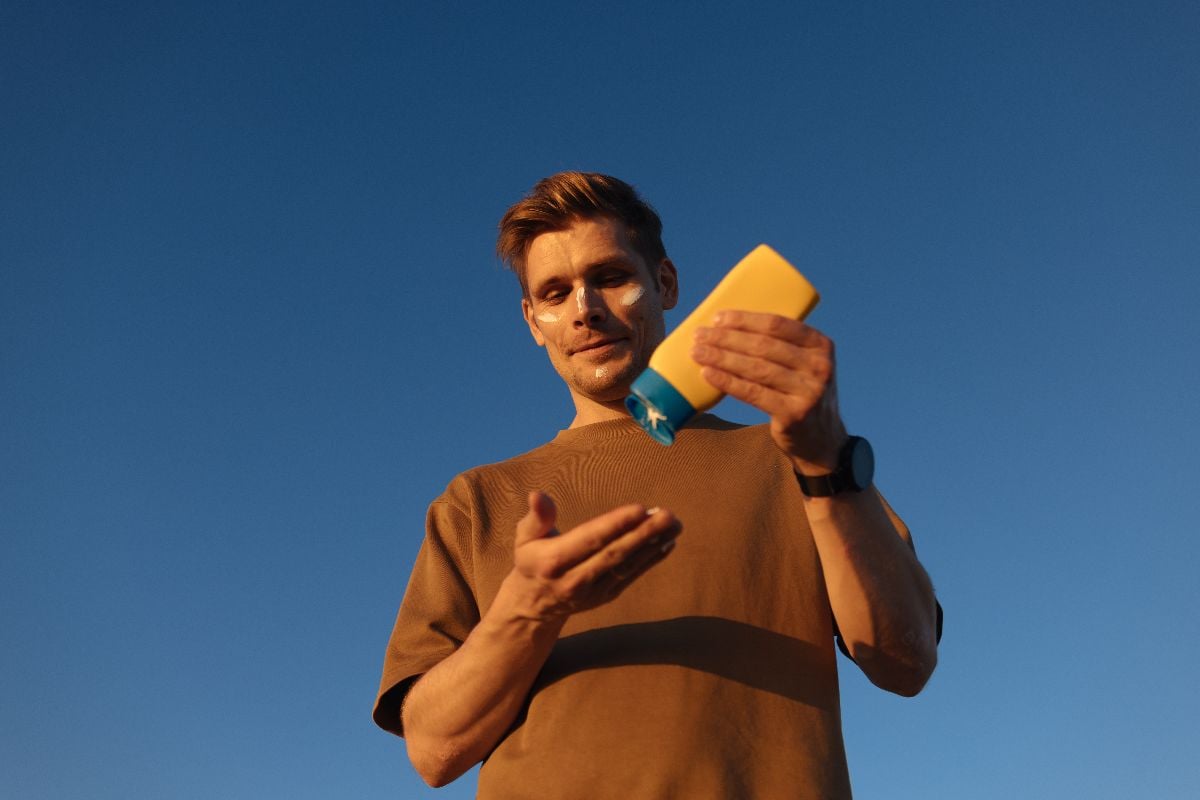 Man applying sunscreen