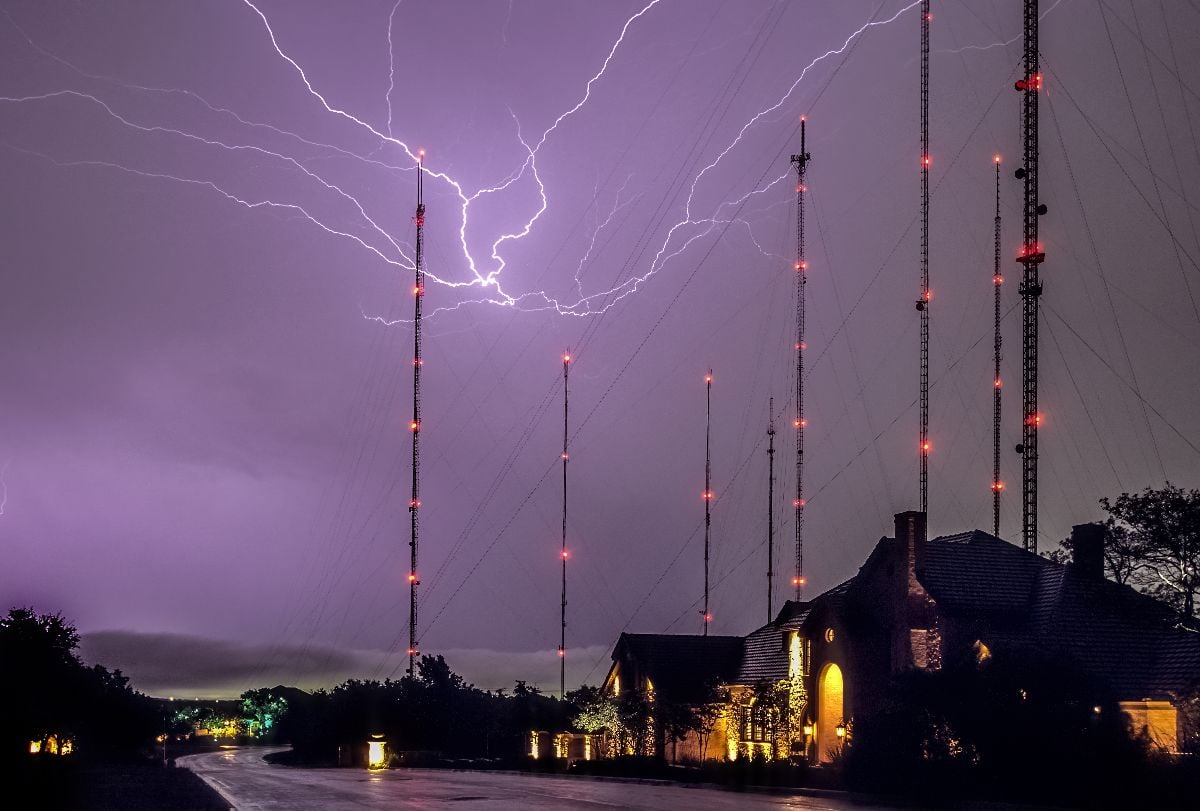 Big lightning bolts over houses and radio towers in Austin Texas.