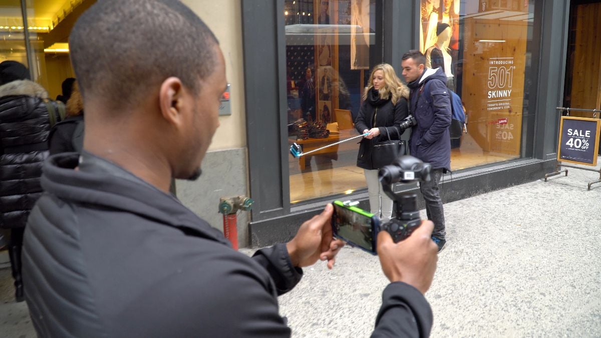 Tourists using selfie sticks.