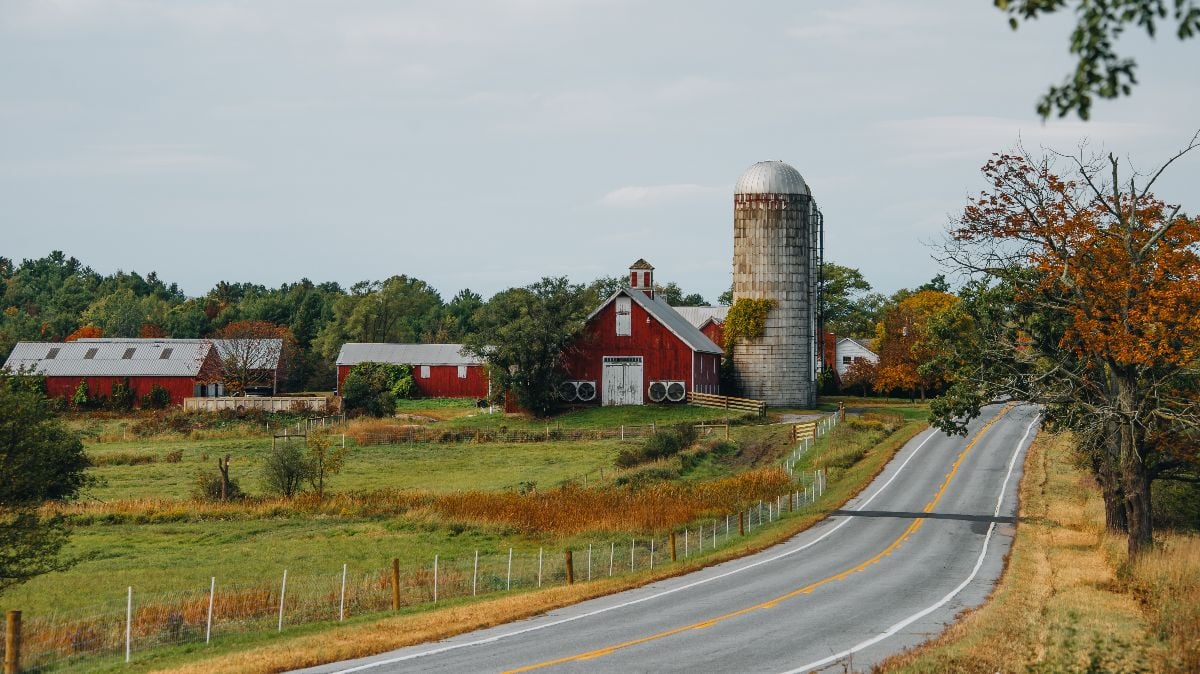 Upstate New York red barn side of the road in autumn.