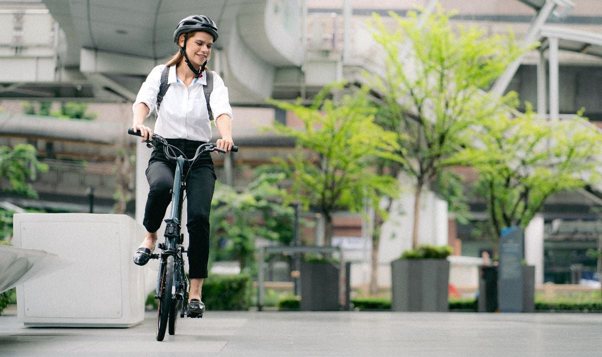 Businesswoman ride bicycle in urban.