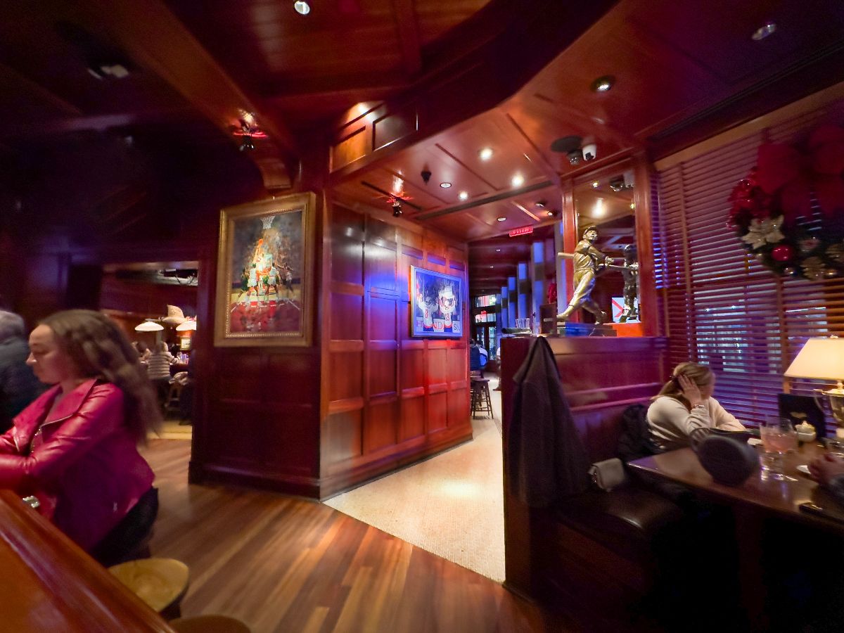 A nighttime view of the bar area of a downtown restaurant.