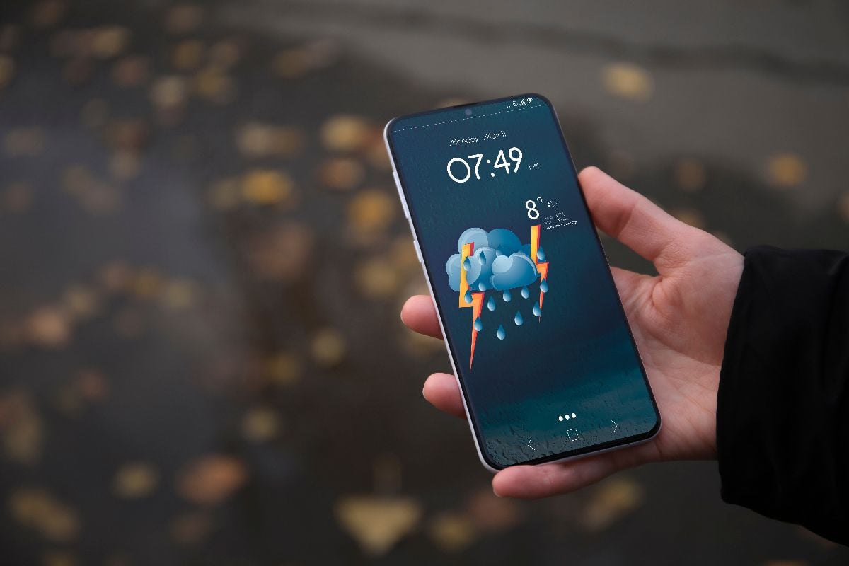 Woman checking weather using app on smartphone.
