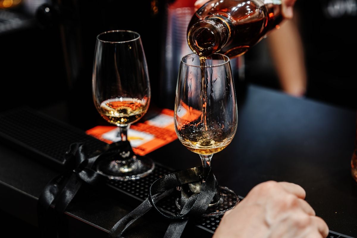 Bartender pours whiskey for tasting.