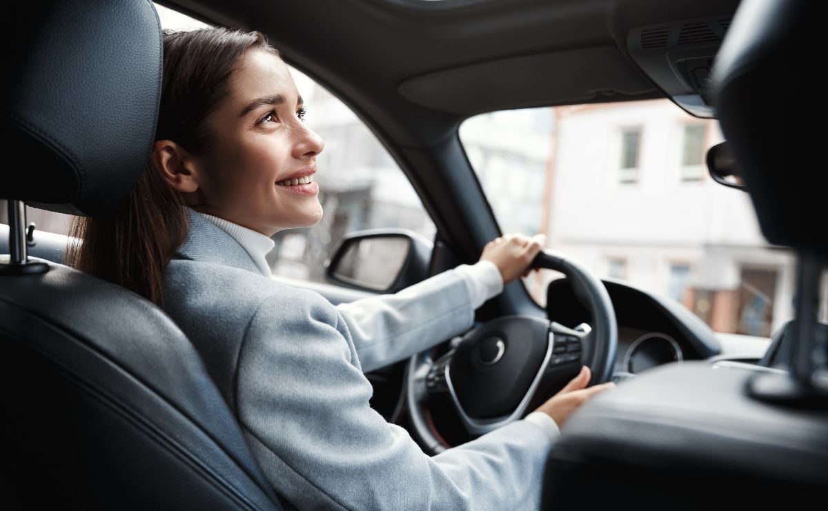 Woman happily driving her car.