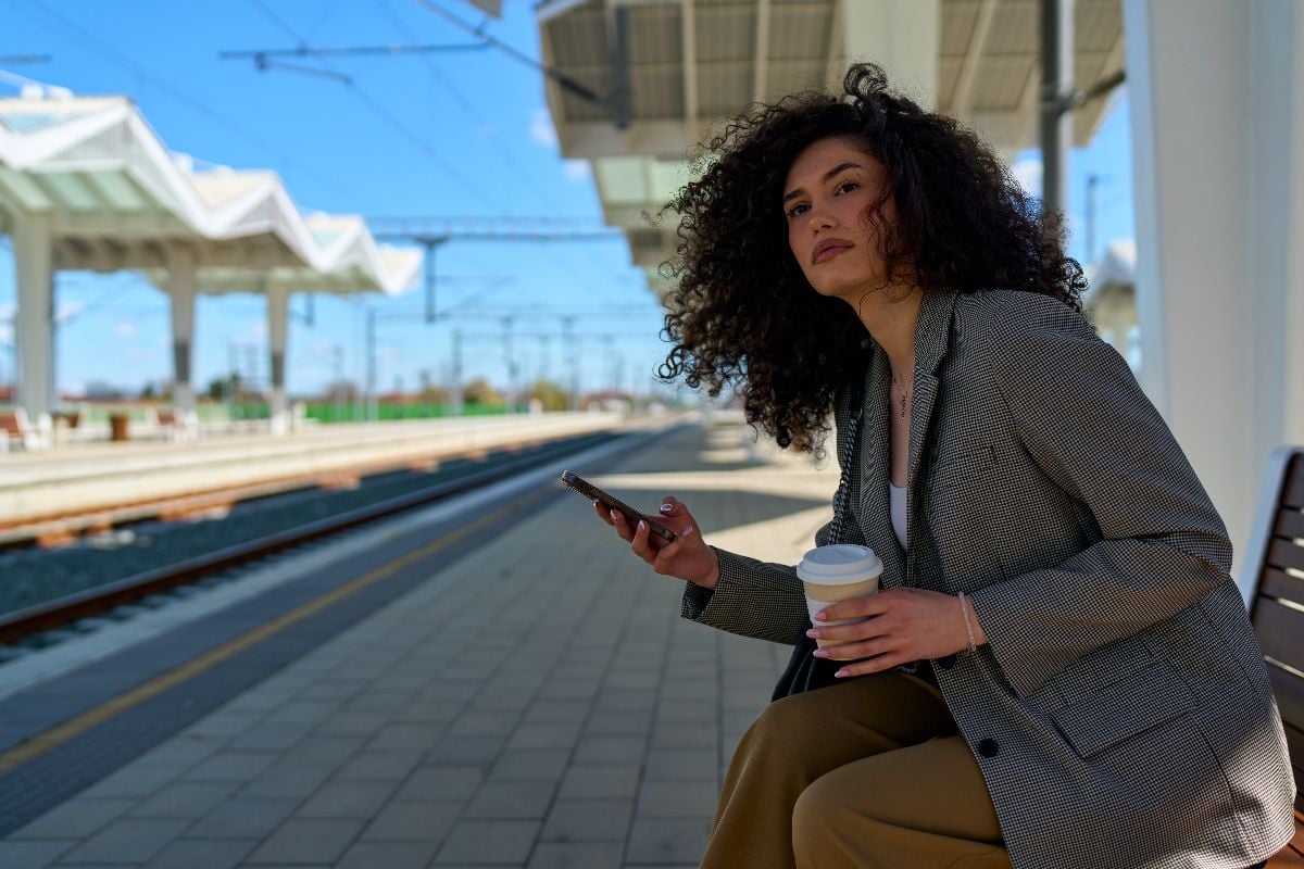 Woman at the train station waiting for someone.
