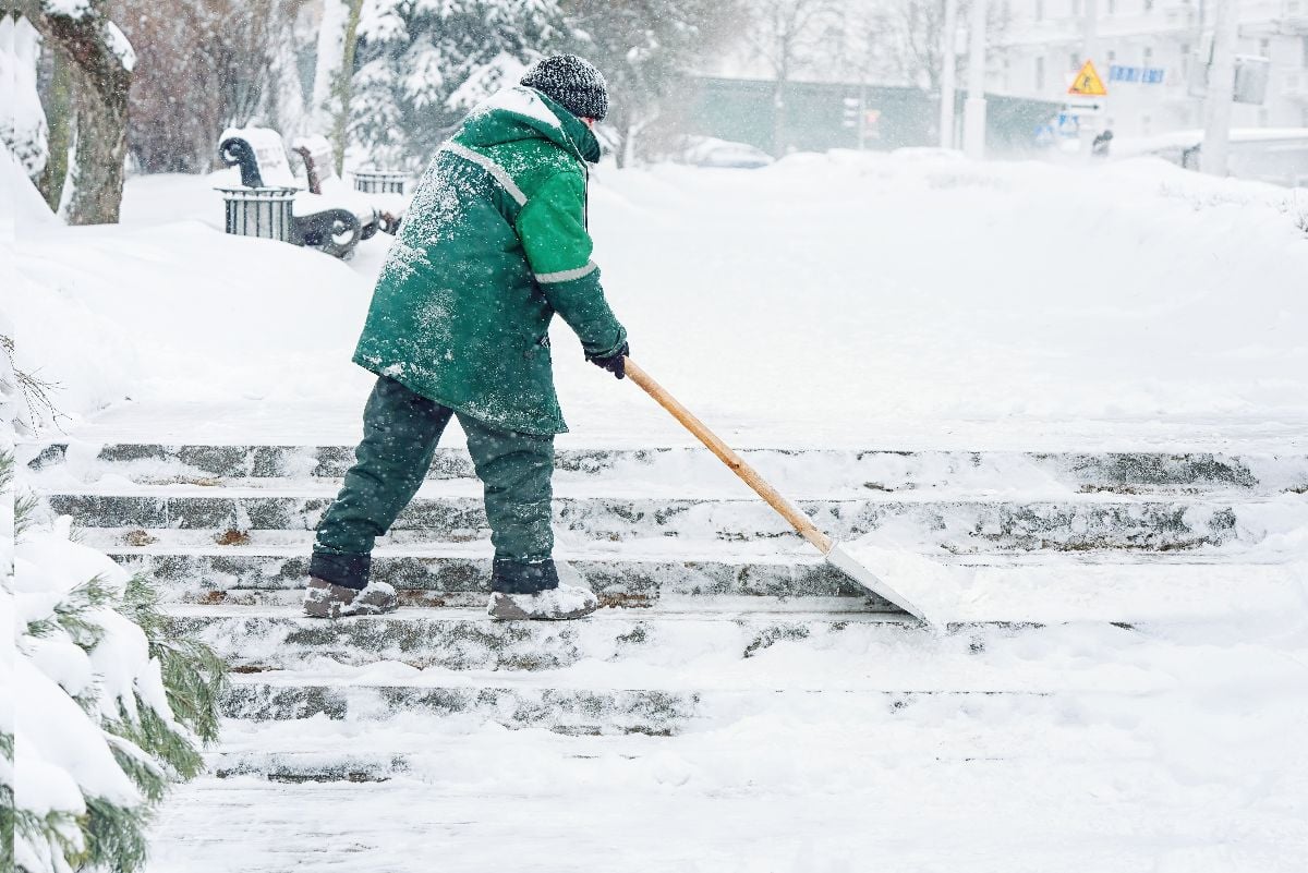 Worker shoveling snow.