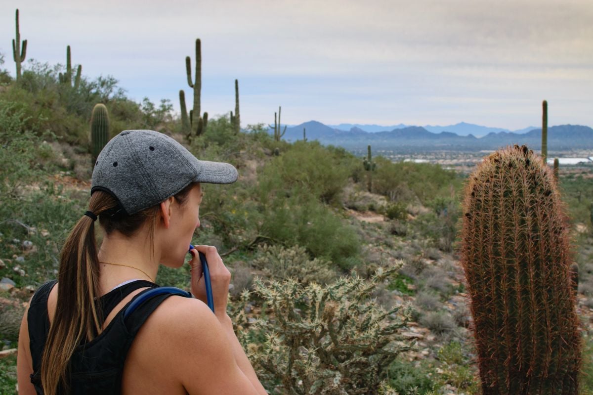 Woman hiking on a desert trail.