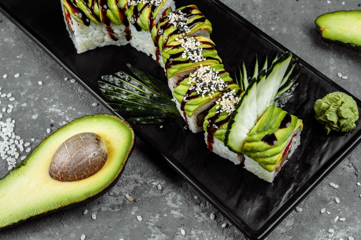 Green dragon sushi roll with avocado, cucumber and ginger.