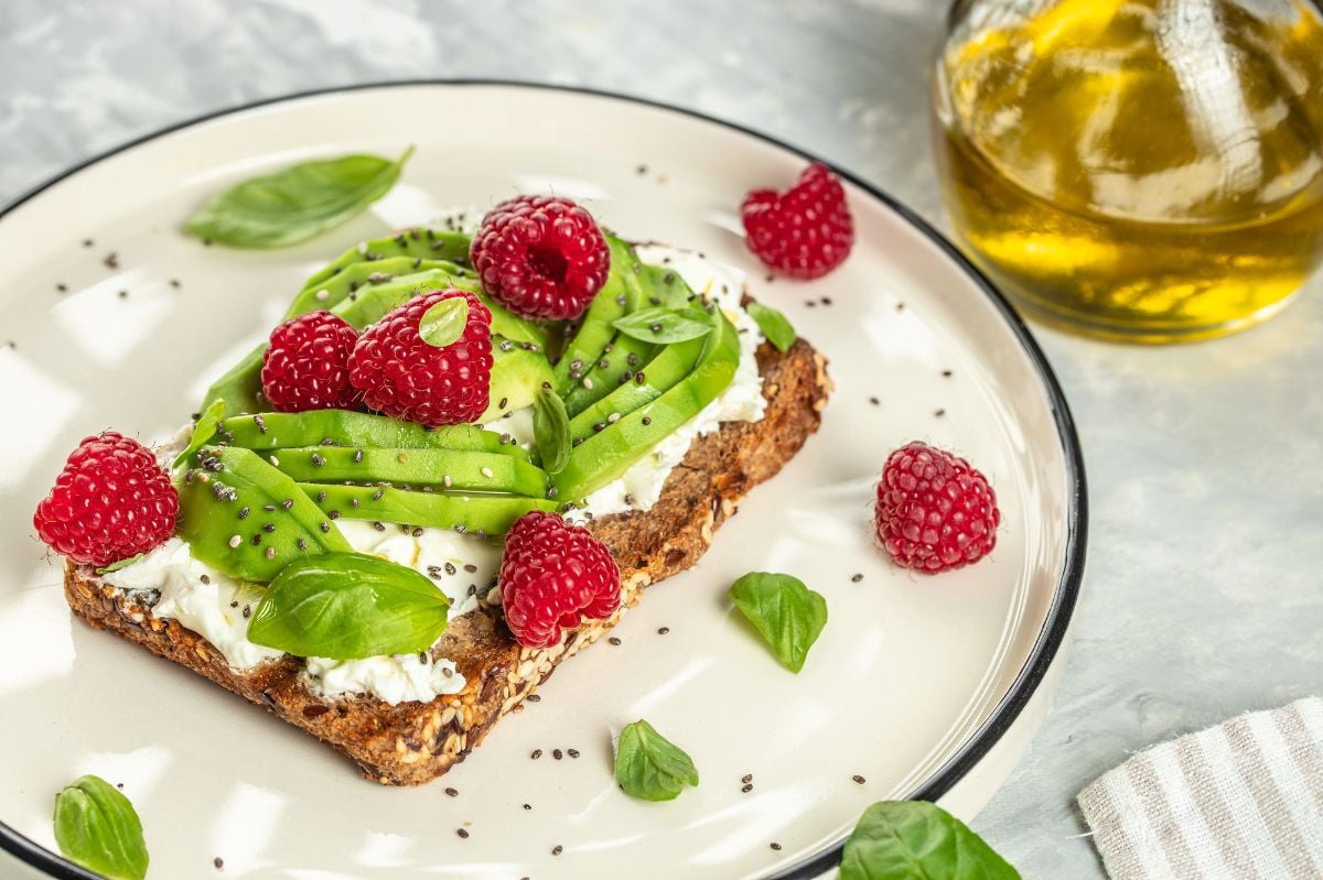Avocado Toast for breakfast or lunch with avocado, raspberries, cream cheese and chia seeds.