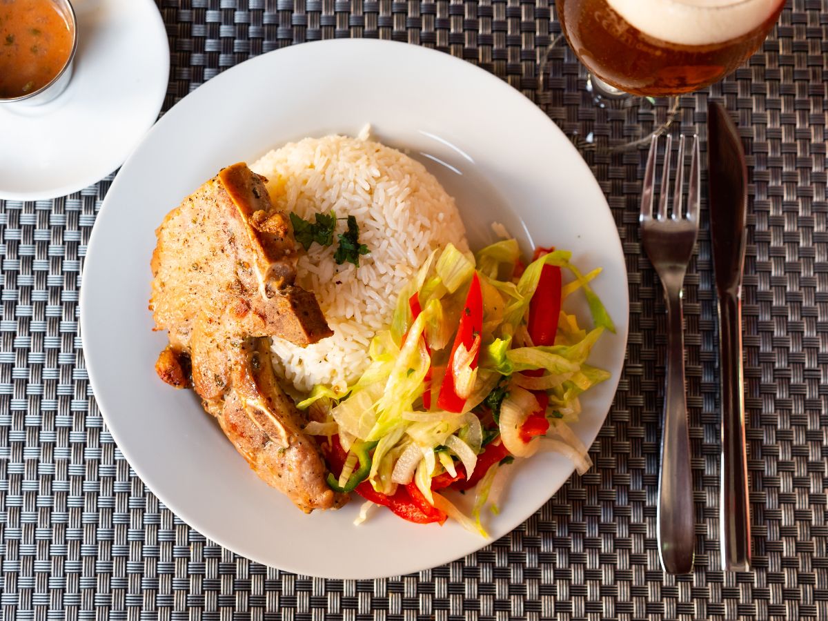 Pork chop with rice and vegetables.