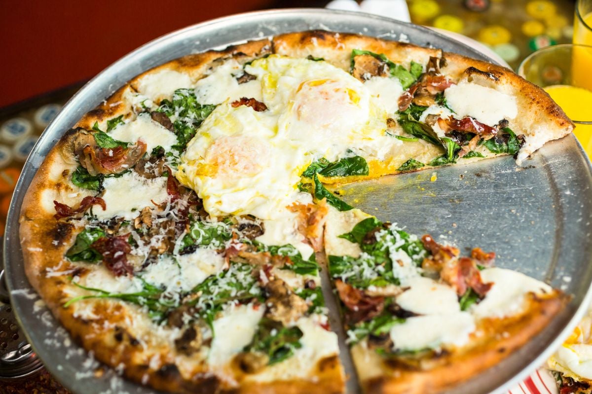Breakfast pizza with three farm fresh eggs.