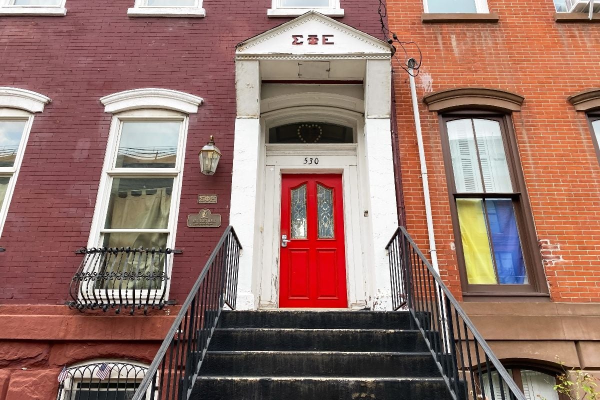 Brownstone entrance with staircase leading to the door.