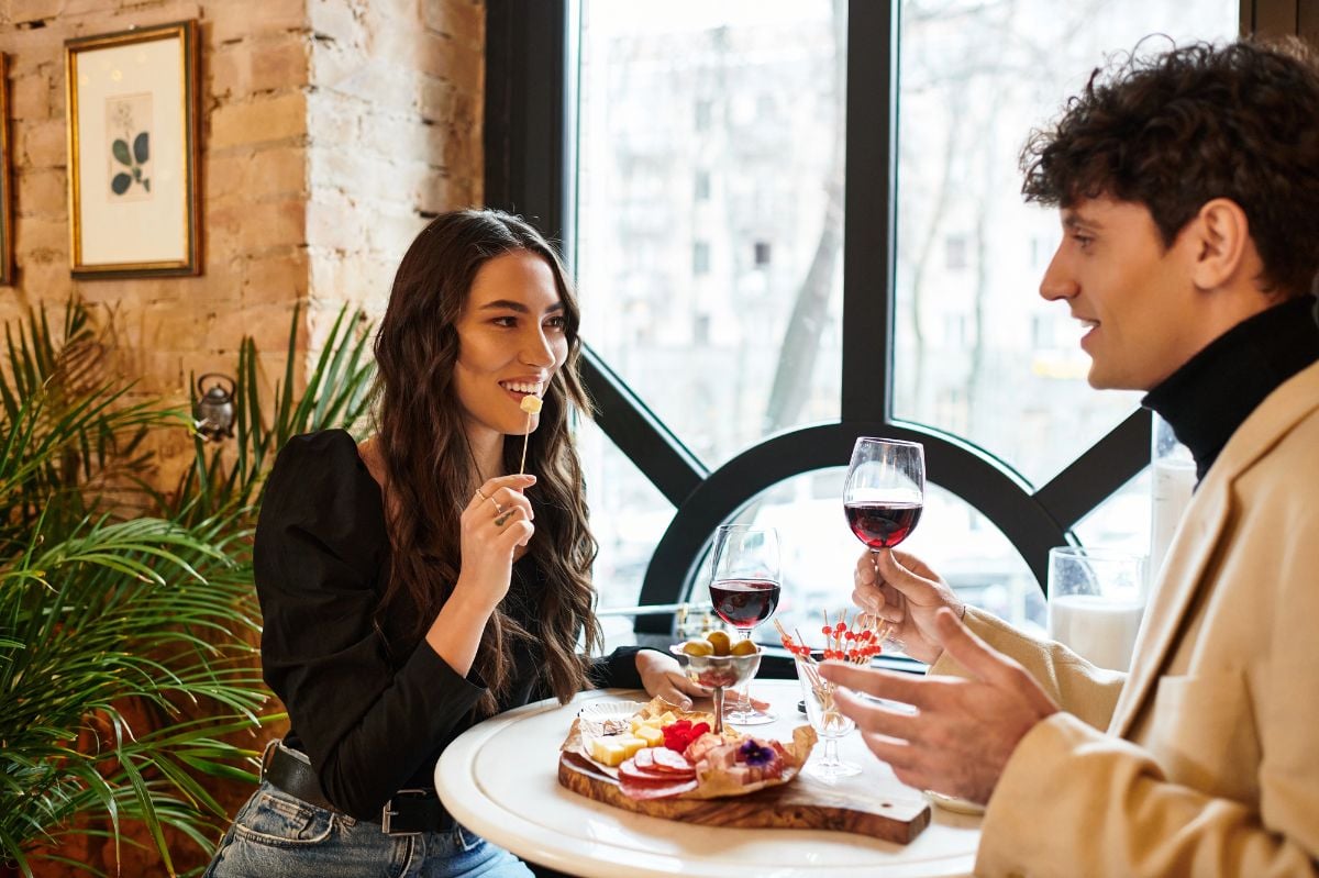 A couple enjoys a romantic meal with wine.