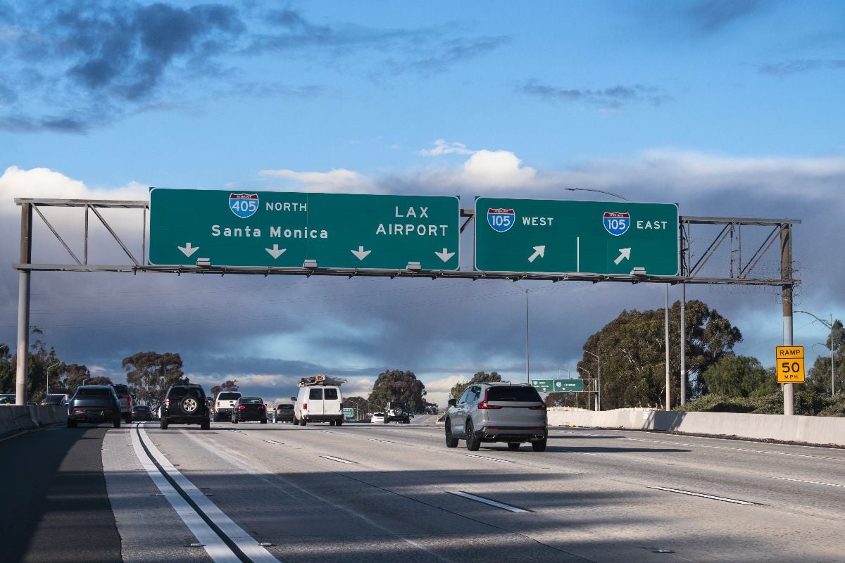 View of 405 Freeway North to Santa Monica and LAX Airport sign at the 105 freeway interchange ramps in Los Angeles California.