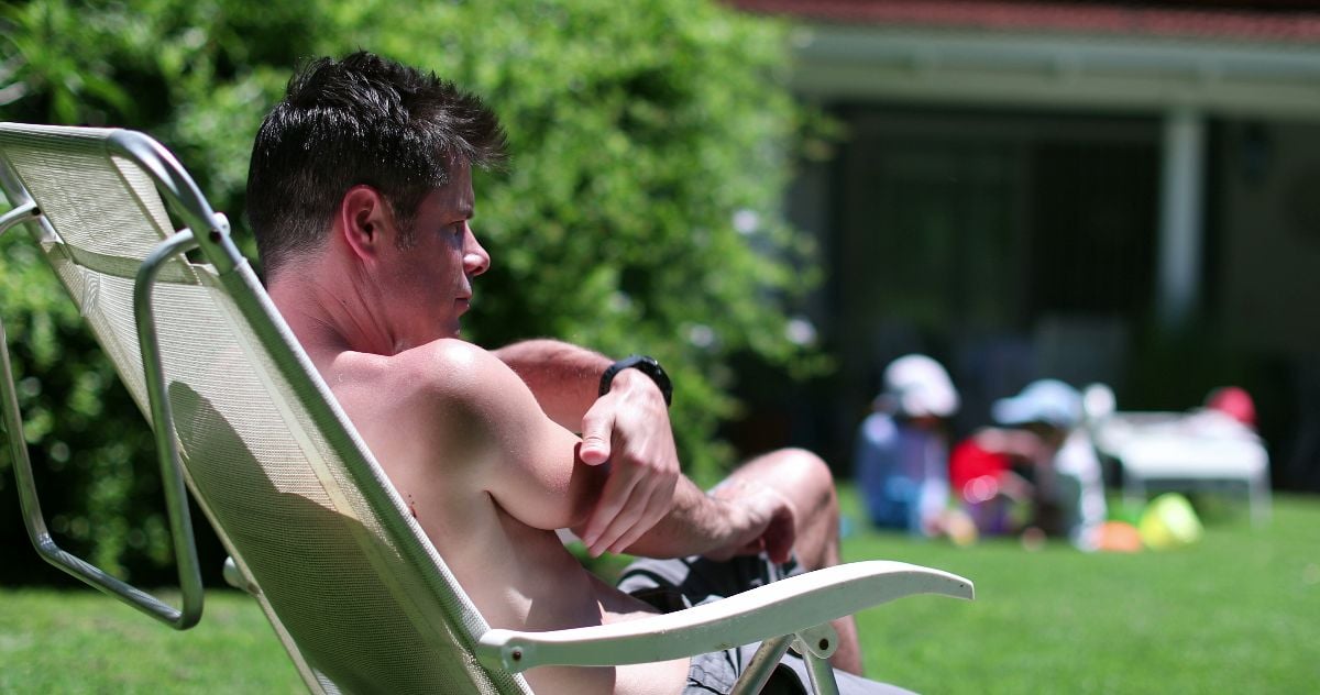 Man scratching arm removing mosquito away.